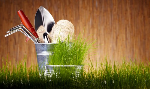 Operative clearing grass cuttings into a waste container